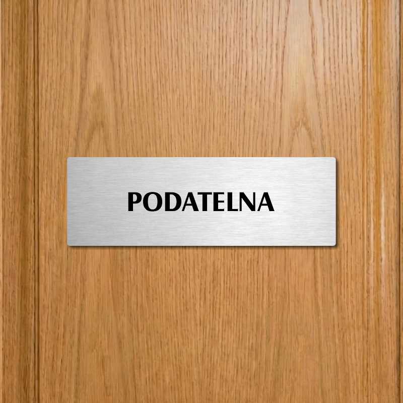 Podatelna, 240x79mm, stříbrná popiska s ozdobou uprostřed
